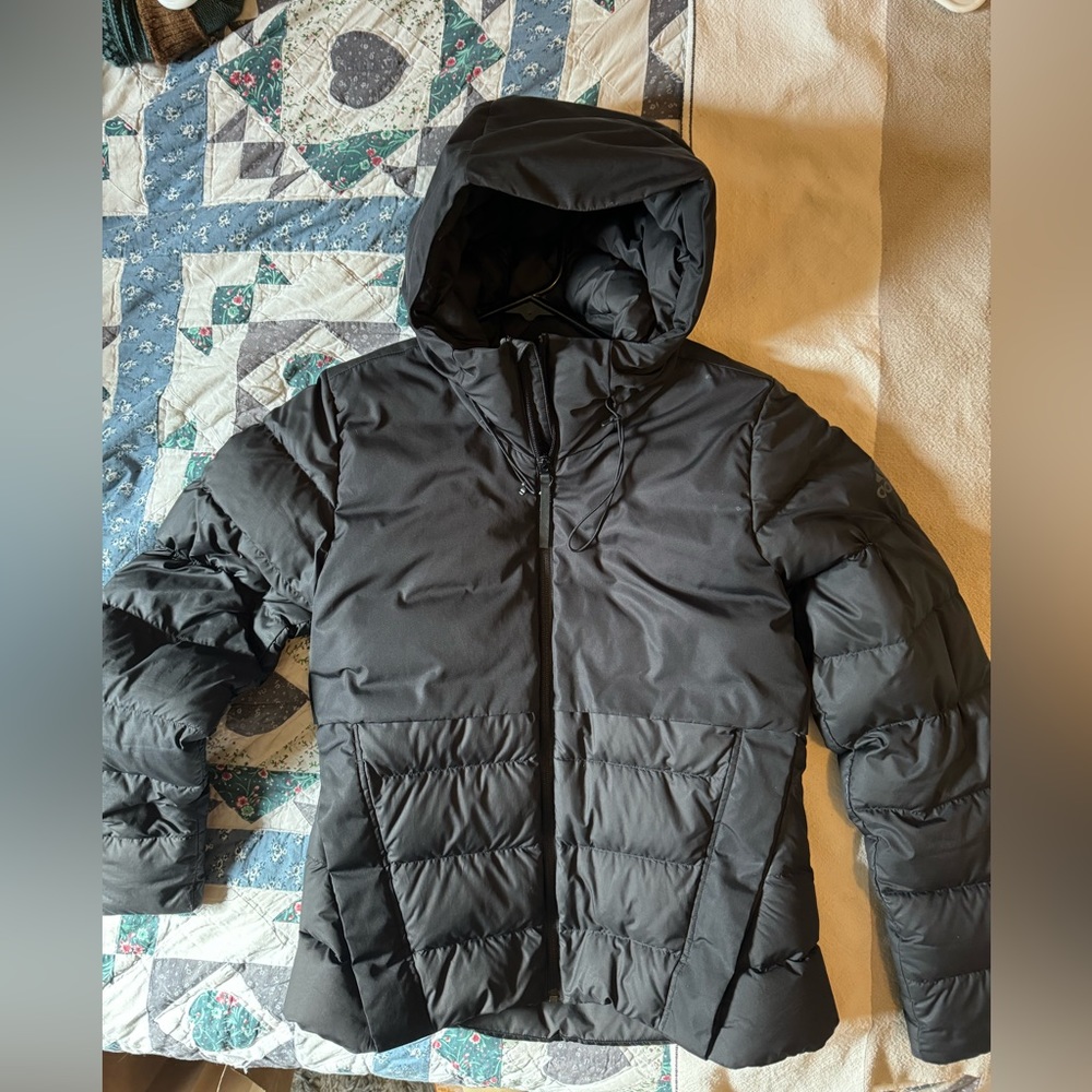 AN INSULATED, WATER-REPELLENT JACKET MADE IN PART WITH RECYCLED